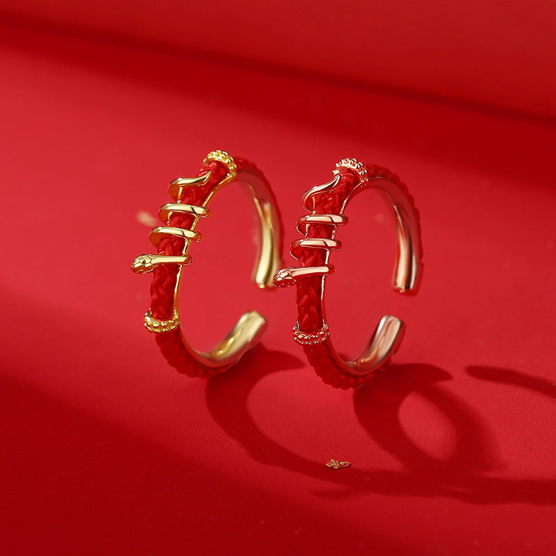 Handcrafted Serpent Ring with red cord, symbolizing wealth, prosperity, and good luck in rose gold.