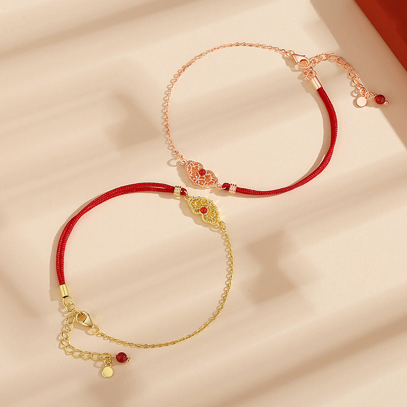 Close-up of the wishful heart lock on the handmade luck bracelet, crafted with S925 silver and red agate.