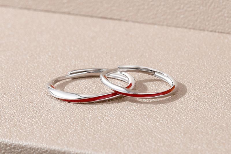 Close-Up of Red Thread Enamel on Möbius Couple Rings for Engagement