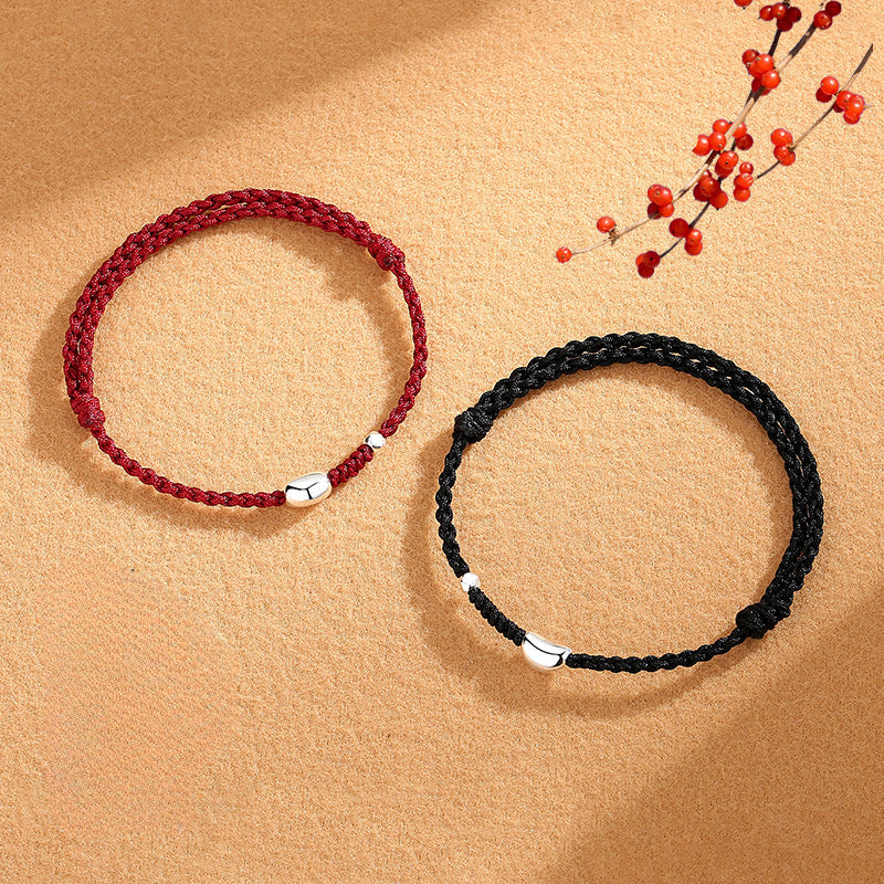 Pair of 925 silver jequirity bean bracelets in red and black with retro woven design, symbolizing love and longing.